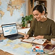 Planning a trip at a desk with a laptop and maps