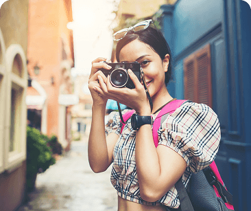 Traveller with a camera on a narrow city street